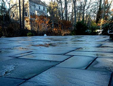 A new stone patio installed in Cohasset, MA.